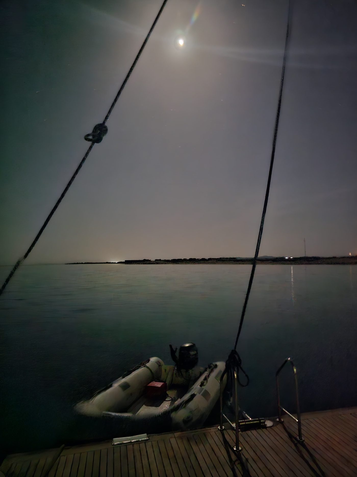 Tenders at anchor by moonlight