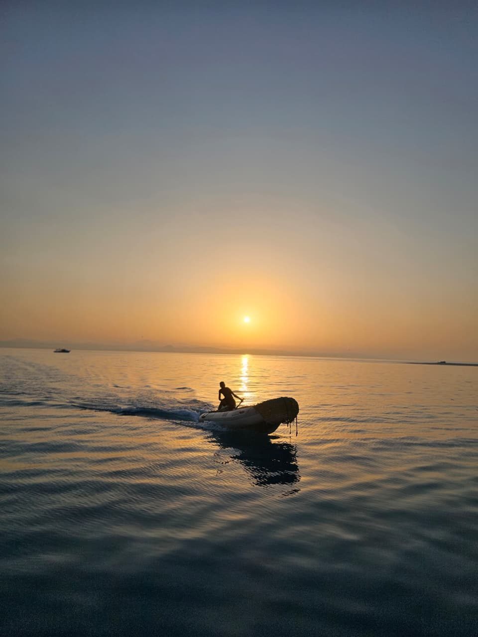Tender boat at sunset